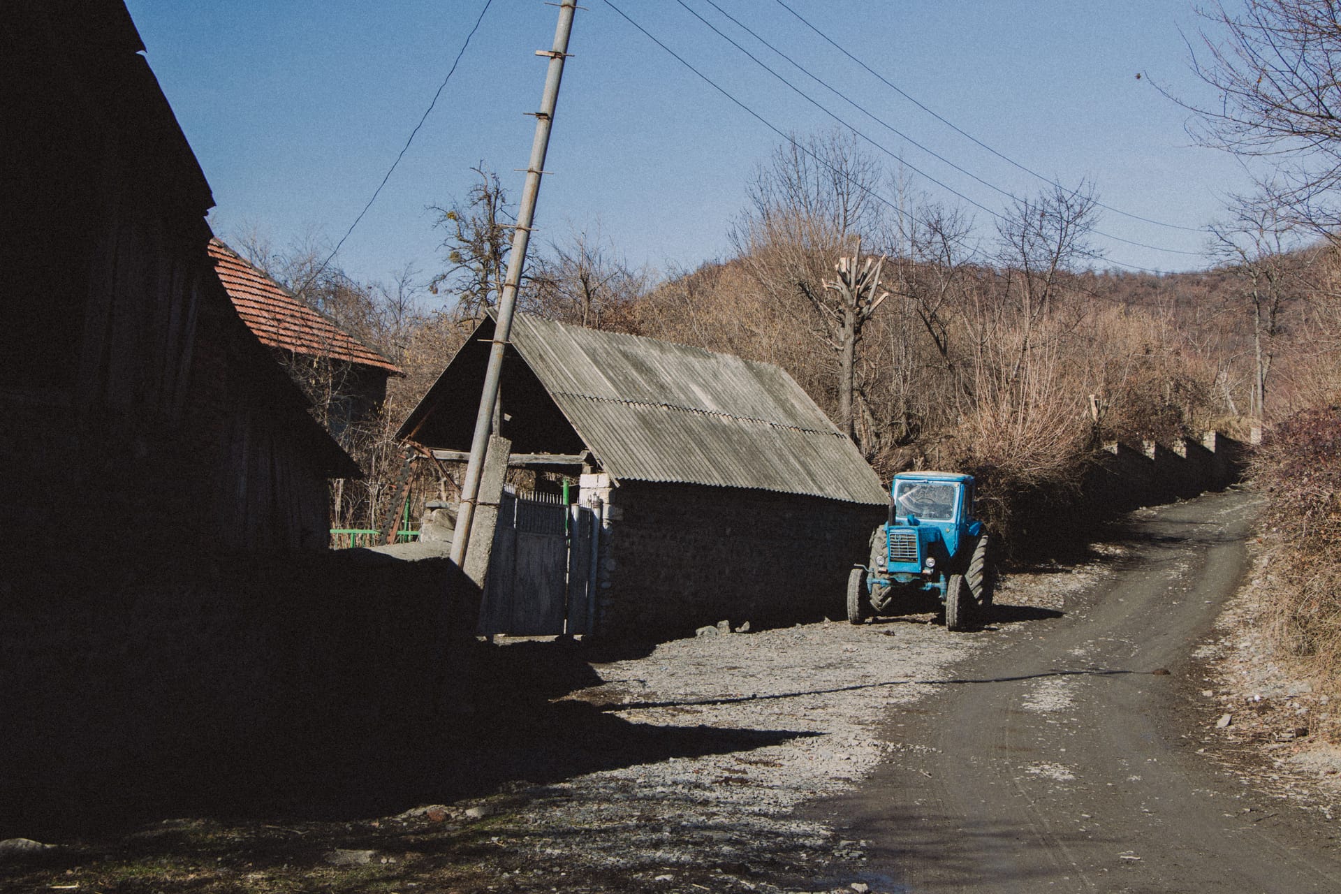 Village wedding on Rote with the road closed, chairs and sunshades set up while neighbours cook together