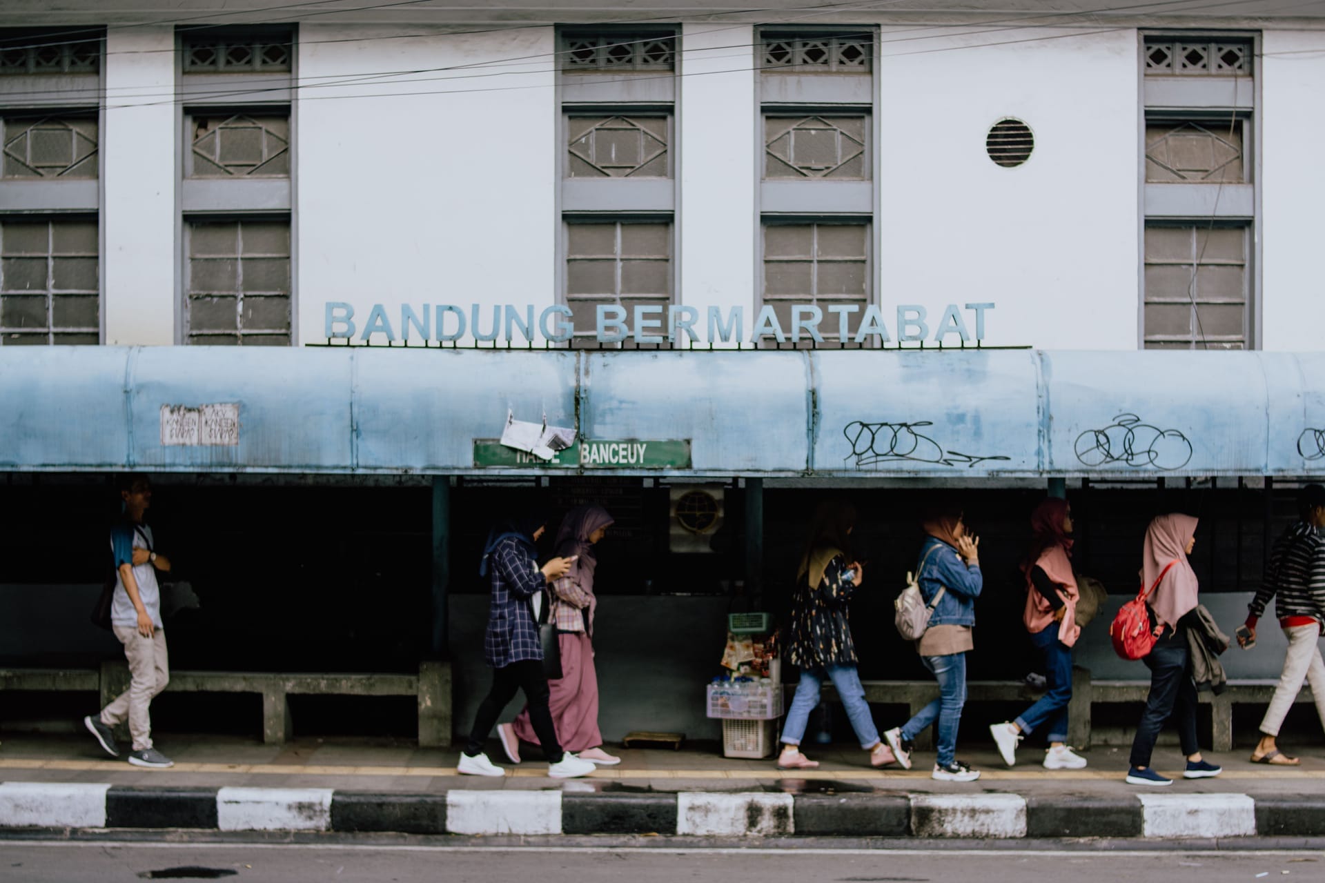 A foreign traveller hands a passport across an immigration counter in Kupang, Timor