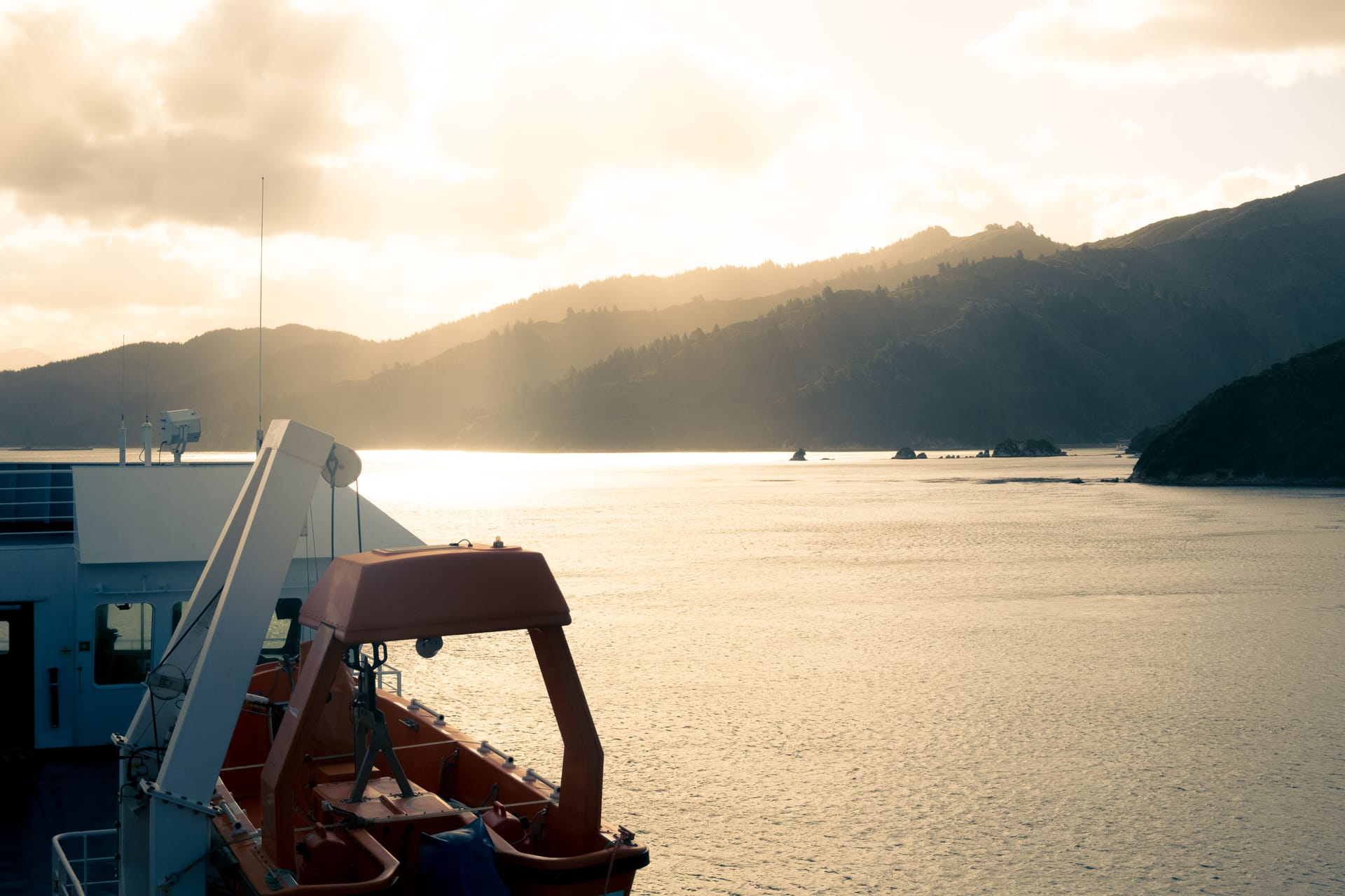 A supply-laden ferry crossing the strait between Timor and Rote Ndao in early-morning light