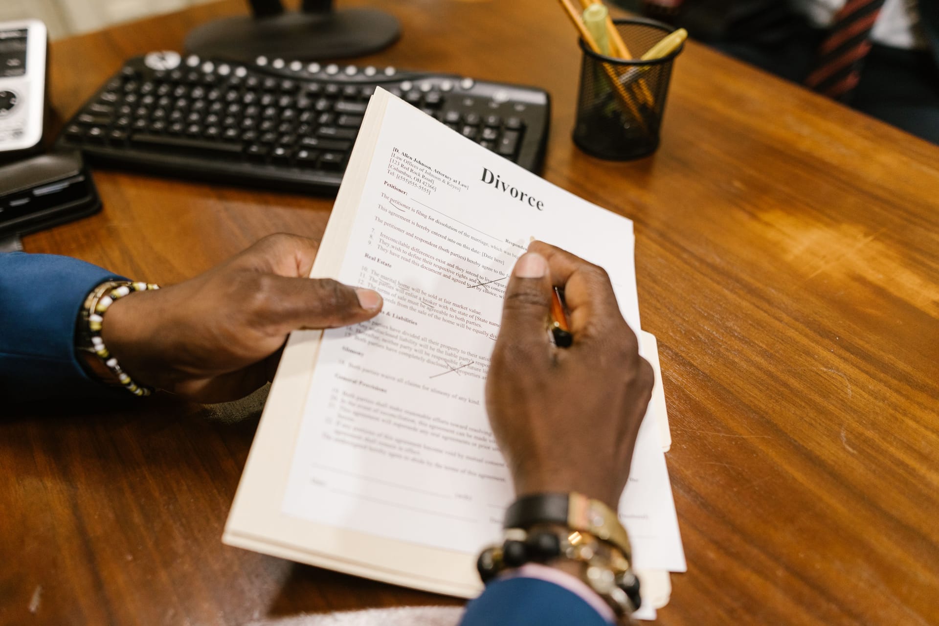 A foreign buyer and a local notary reviewing a property certificate at a desk on Rote Island