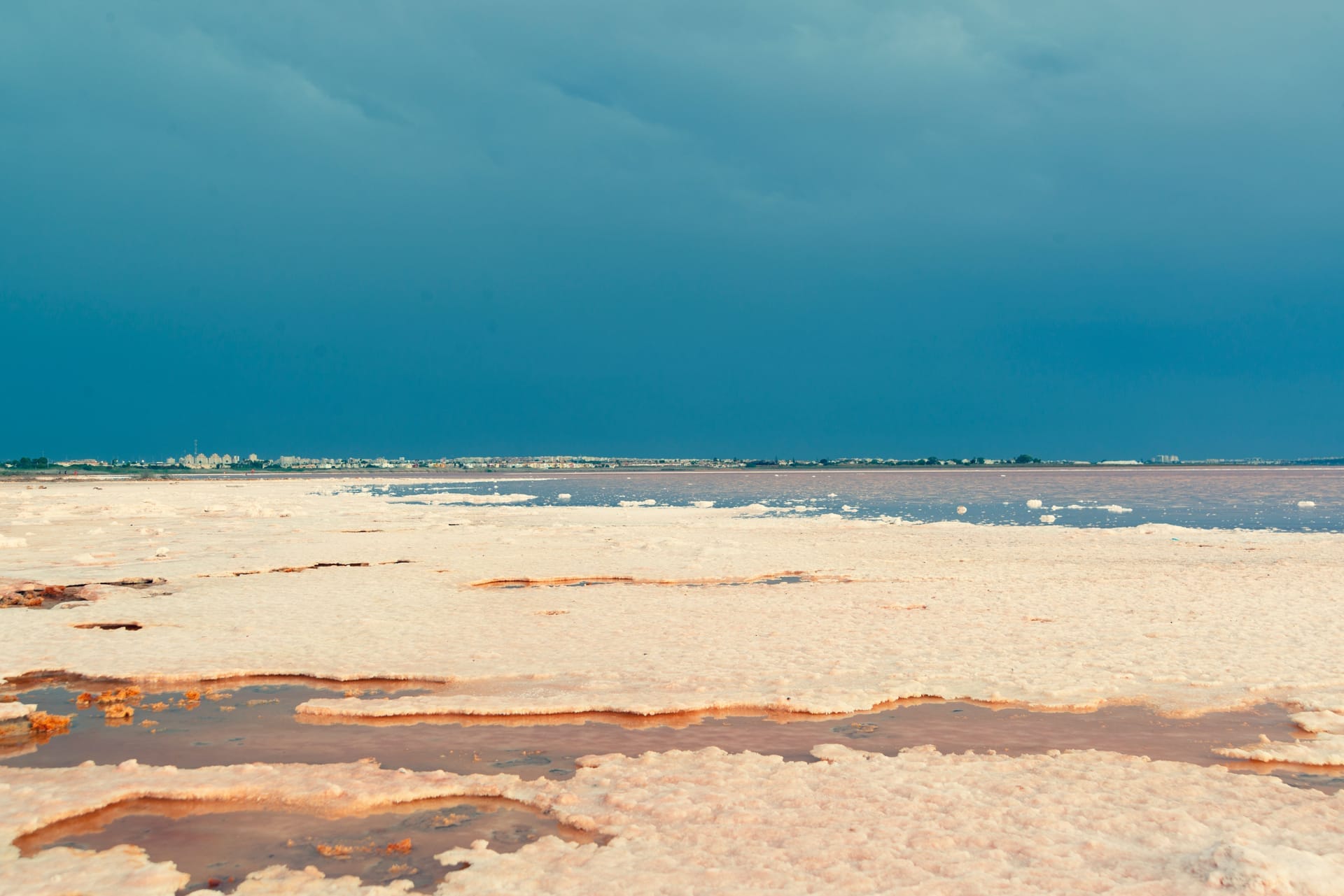 Hand-worked salt flats on Rote Island with shallow ponds and white salt crust under strong sun