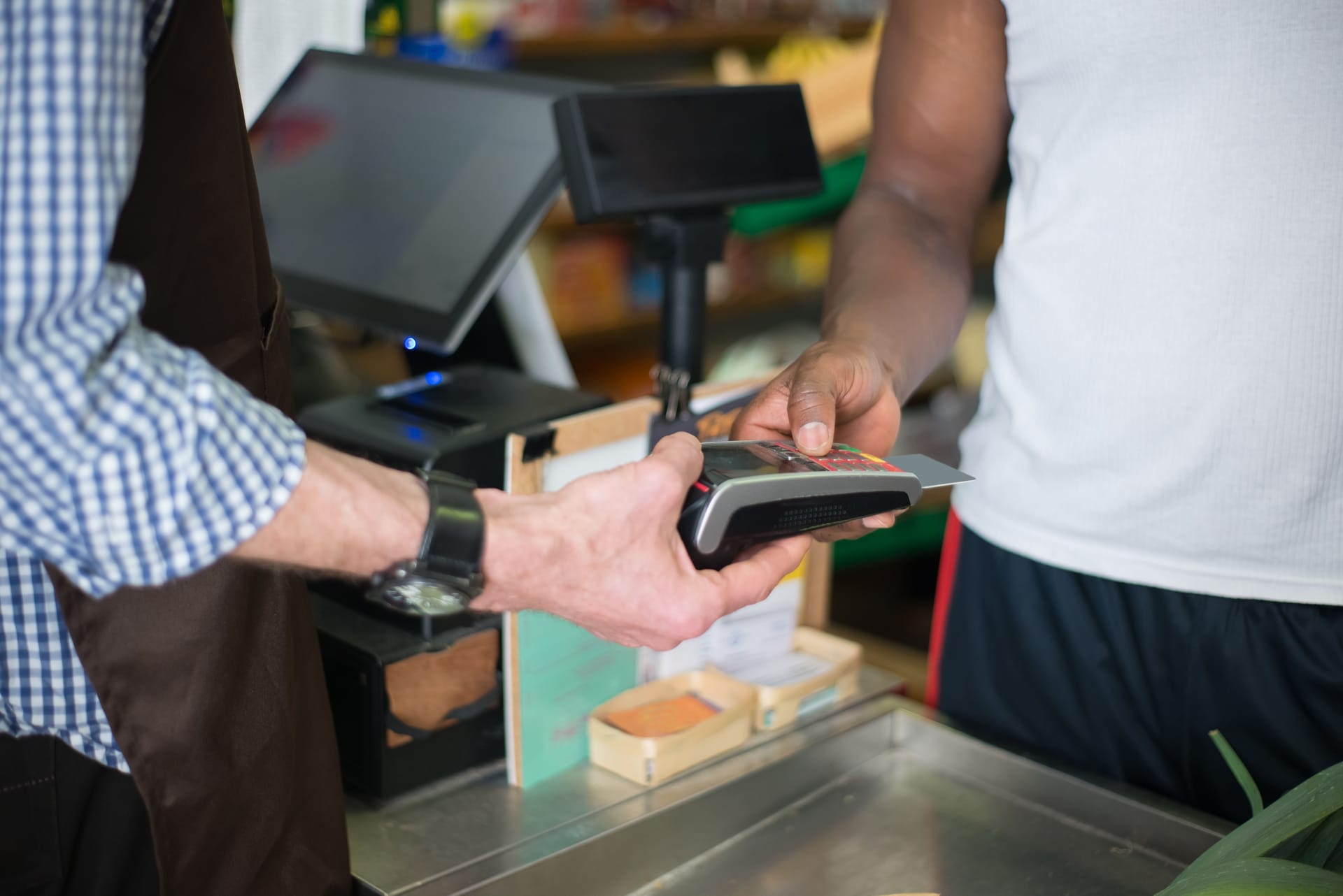 Local shop clerk registering a prepaid SIM card with a passport at a small phone kiosk on Rote island