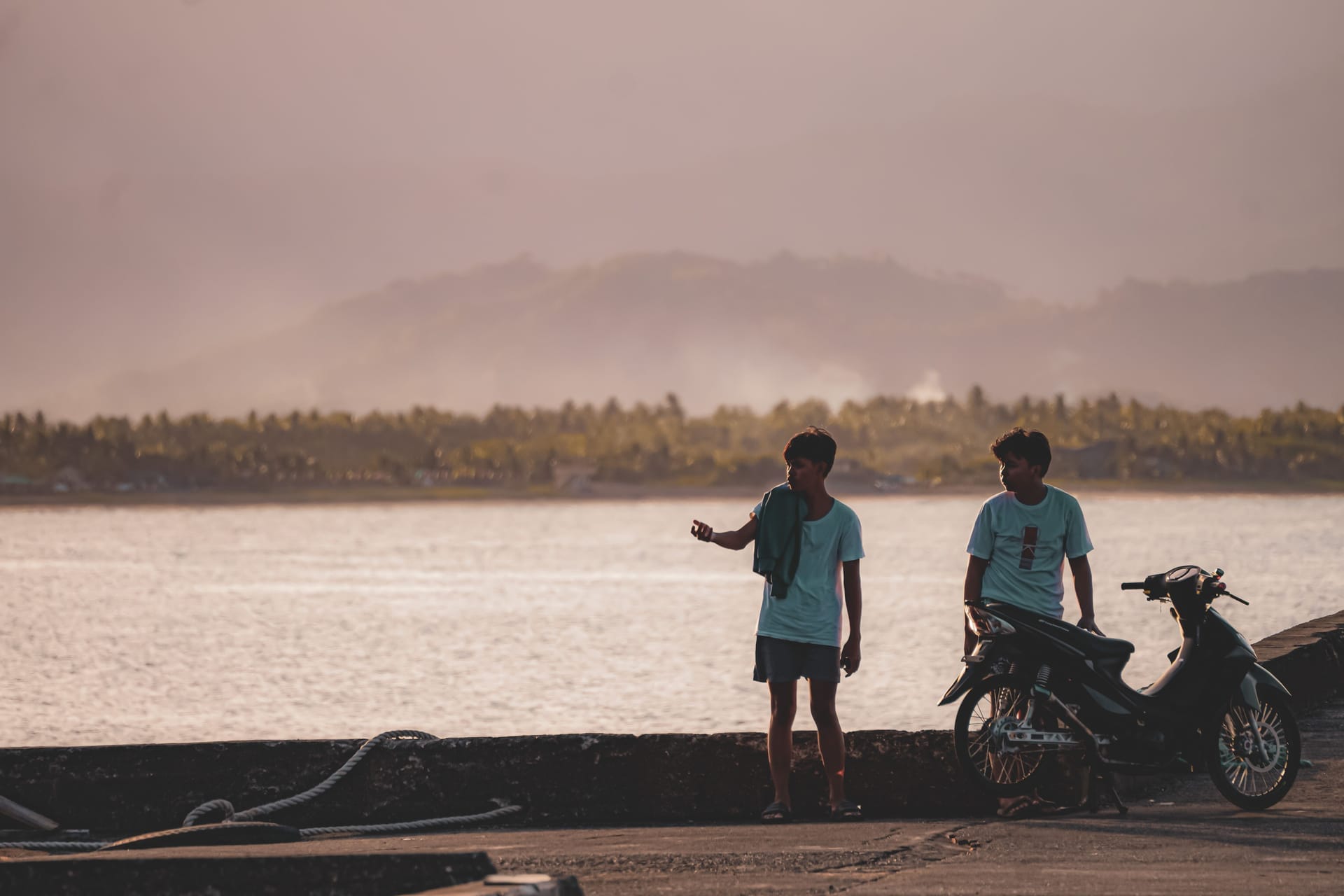 Traveler holding a passport and documents at a Rote ferry terminal at dawn, planning a long stay in Indonesia