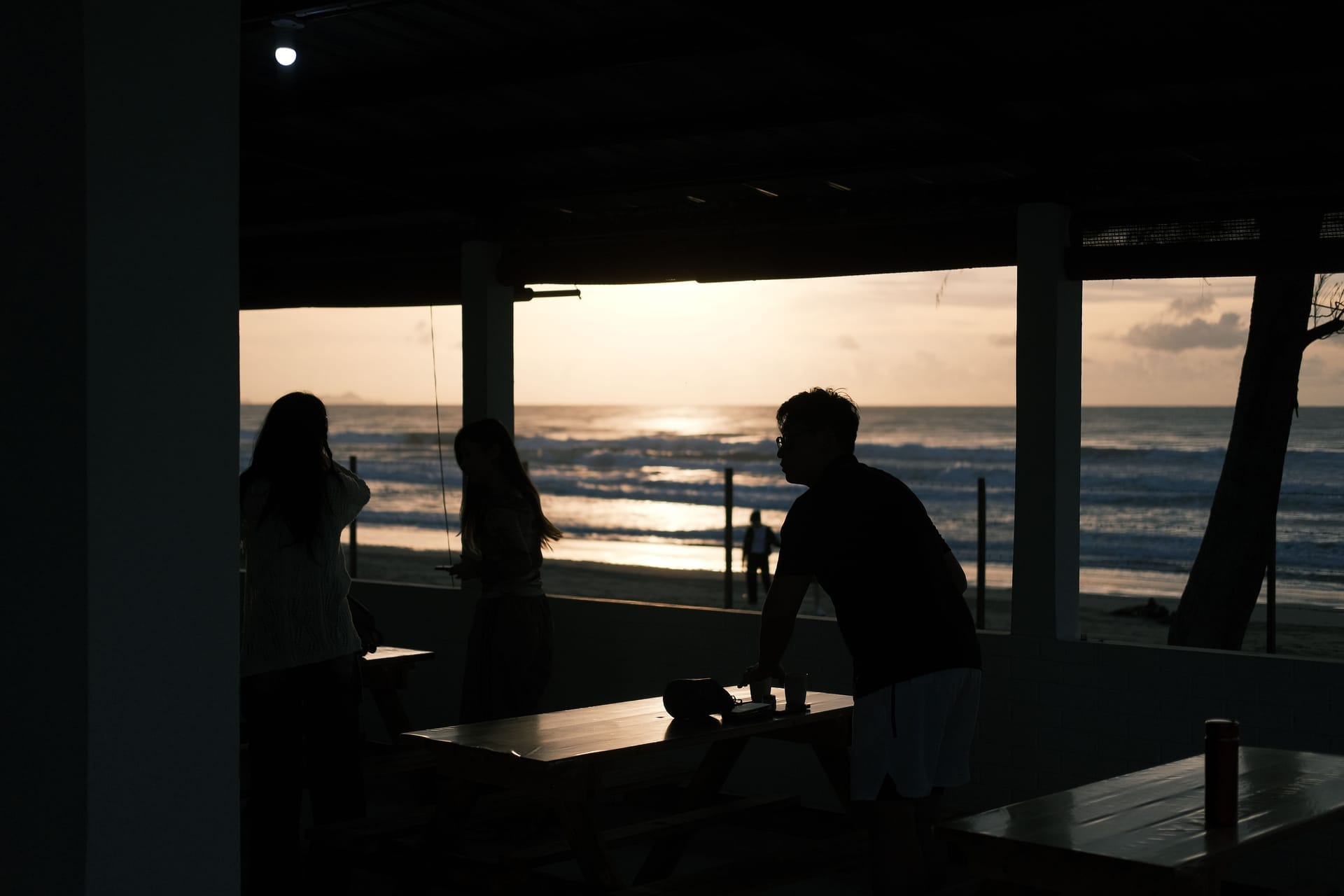 Expats and locals sharing coffee at a beachfront warung on Rote island in Indonesia