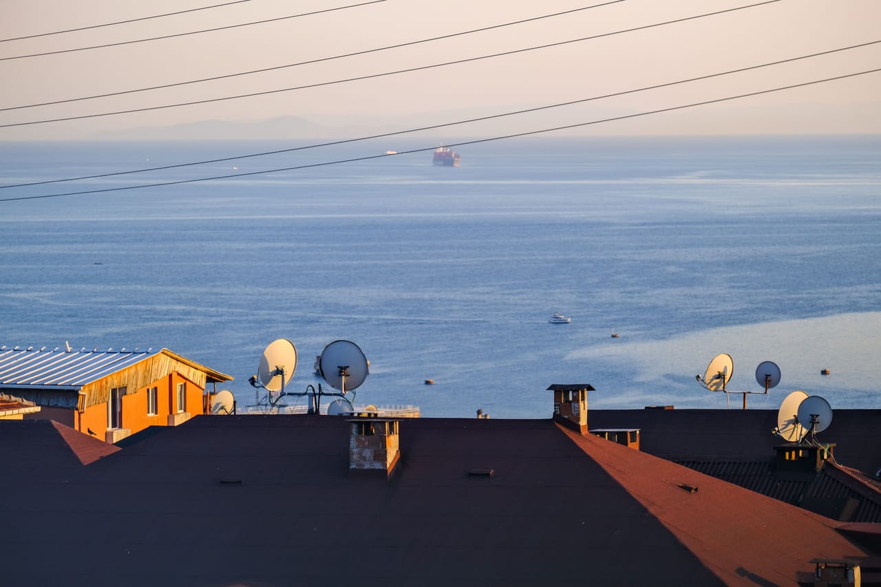 Starlink satellite dish on a local home roof on Rote island with ocean behind