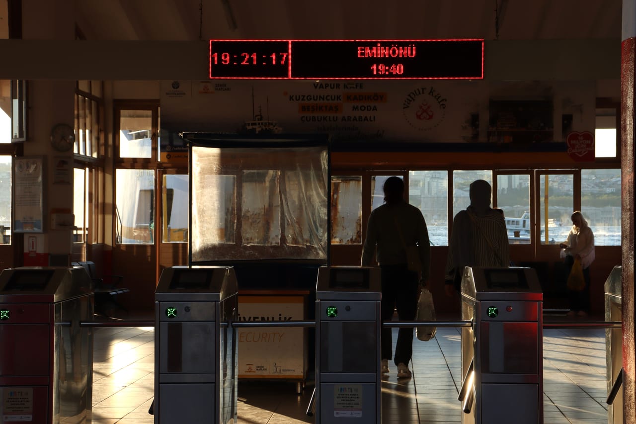 Traveler checking crossing times at a ticket counter in Kupang before continuing to Rote