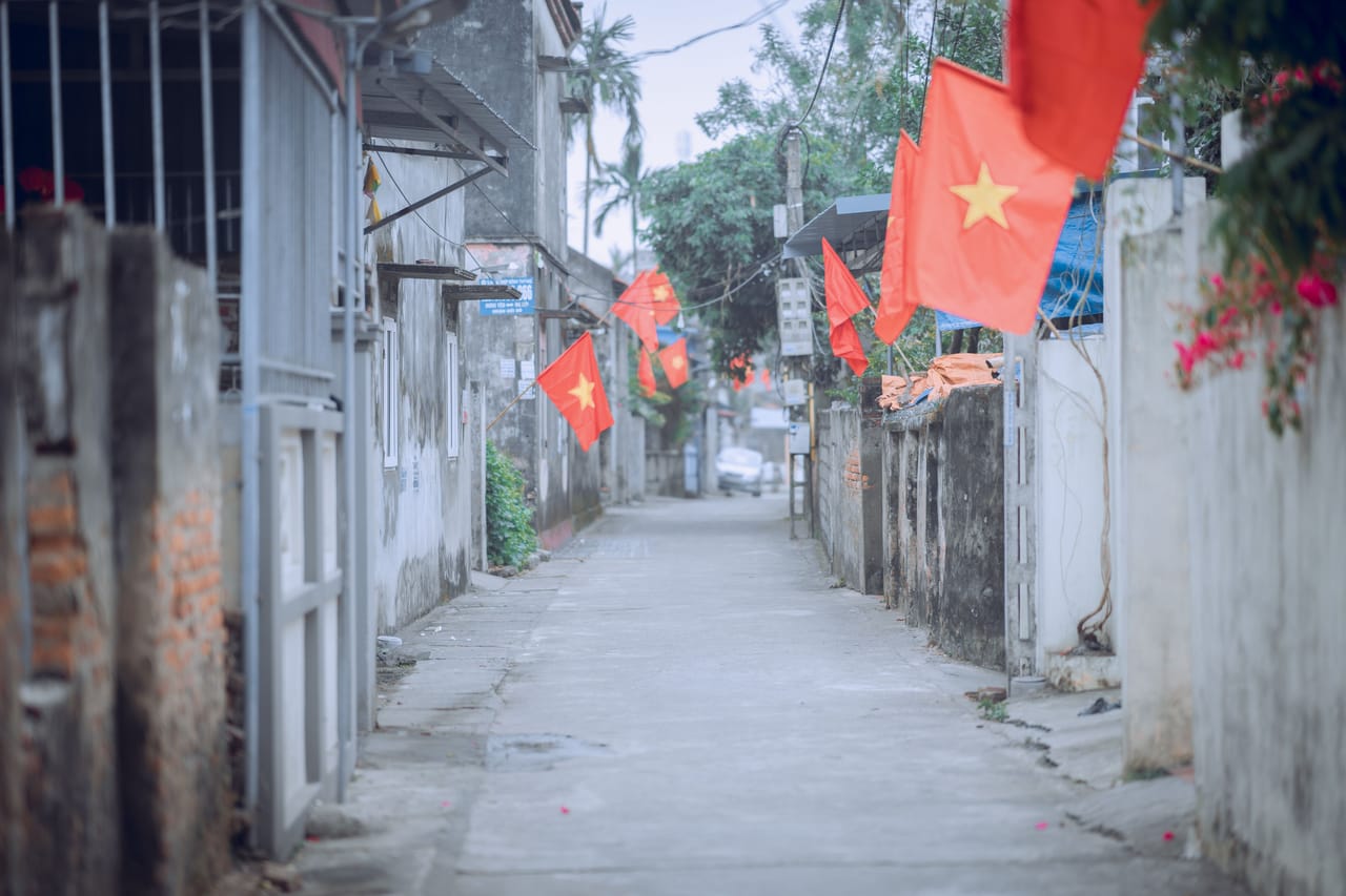 Villagers hanging Indonesian flags along a dirt road on Rote for the August independence celebrations