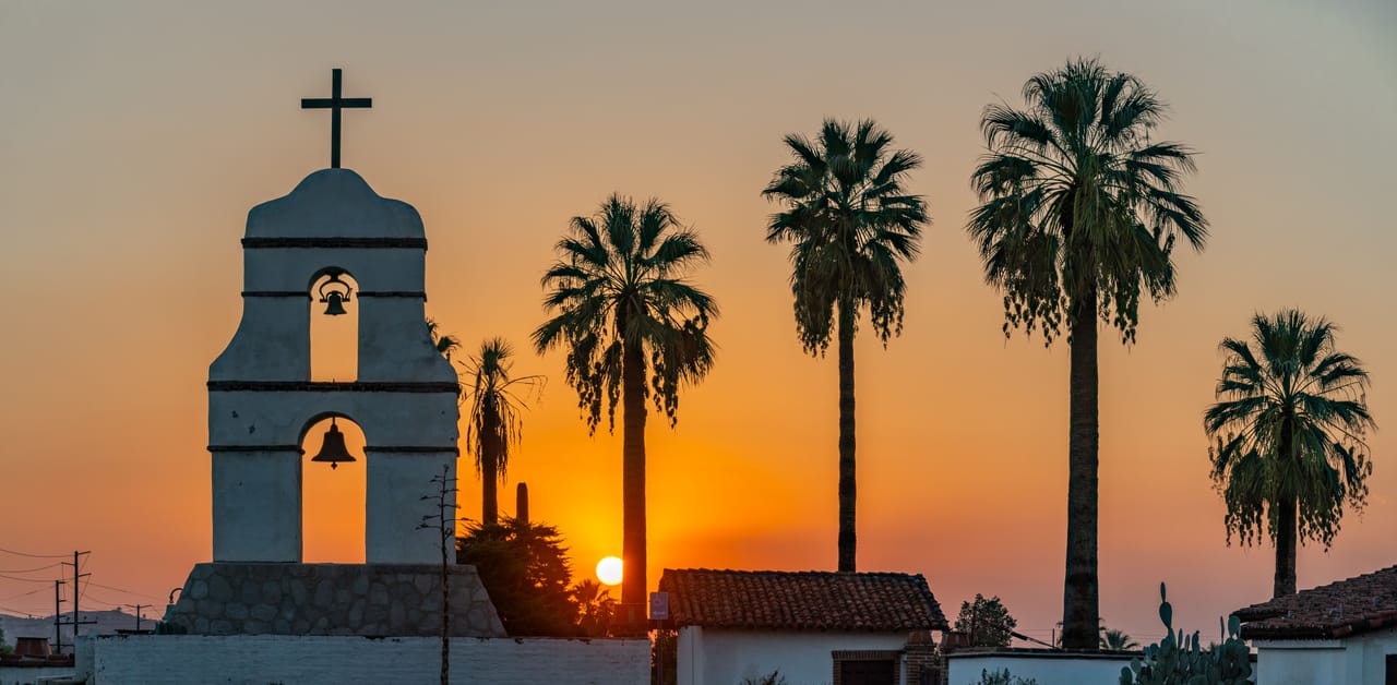 A local church on Rote island with families gathered outside for a Christian holiday at dusk