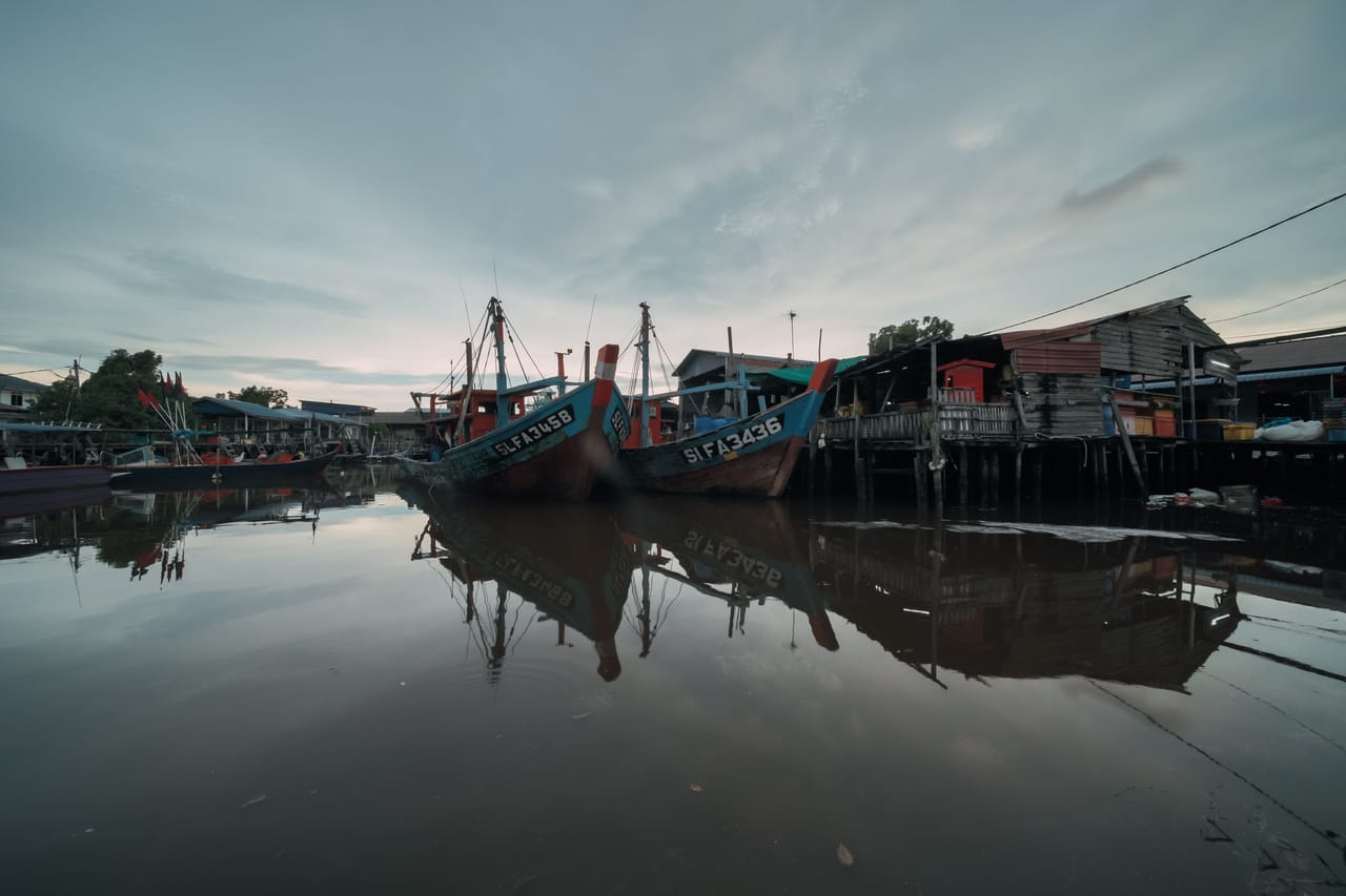 Vendors selling fresh fish and produce at Pasar Oeba market beside the pier in Kupang