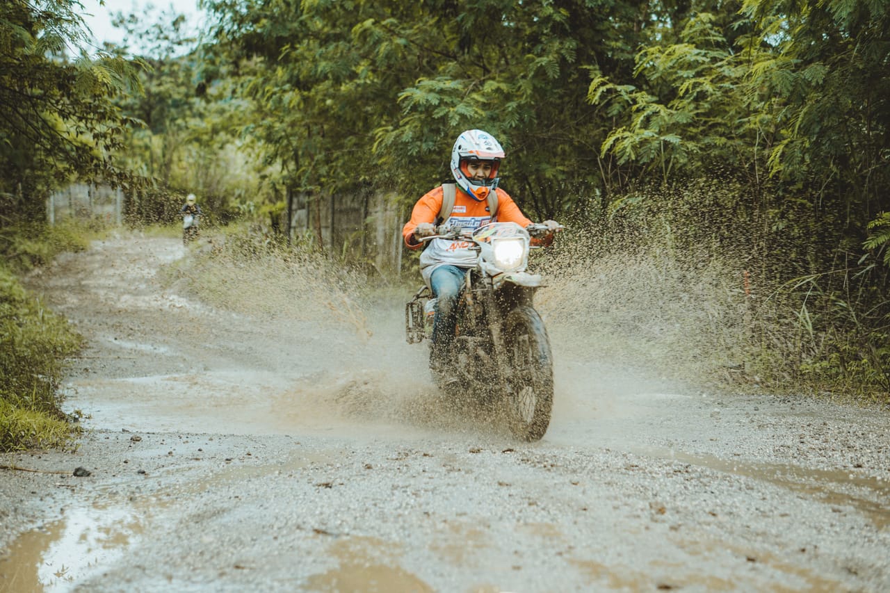 A rain-soaked dirt track leading to interior farmland on Rote island