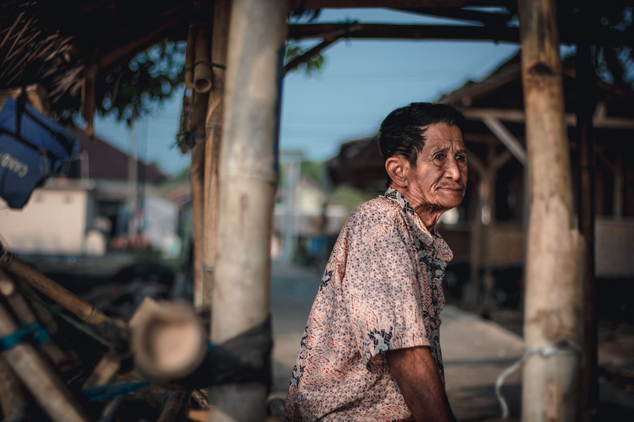 A weathered local warung with a Rotenese family going about everyday island life