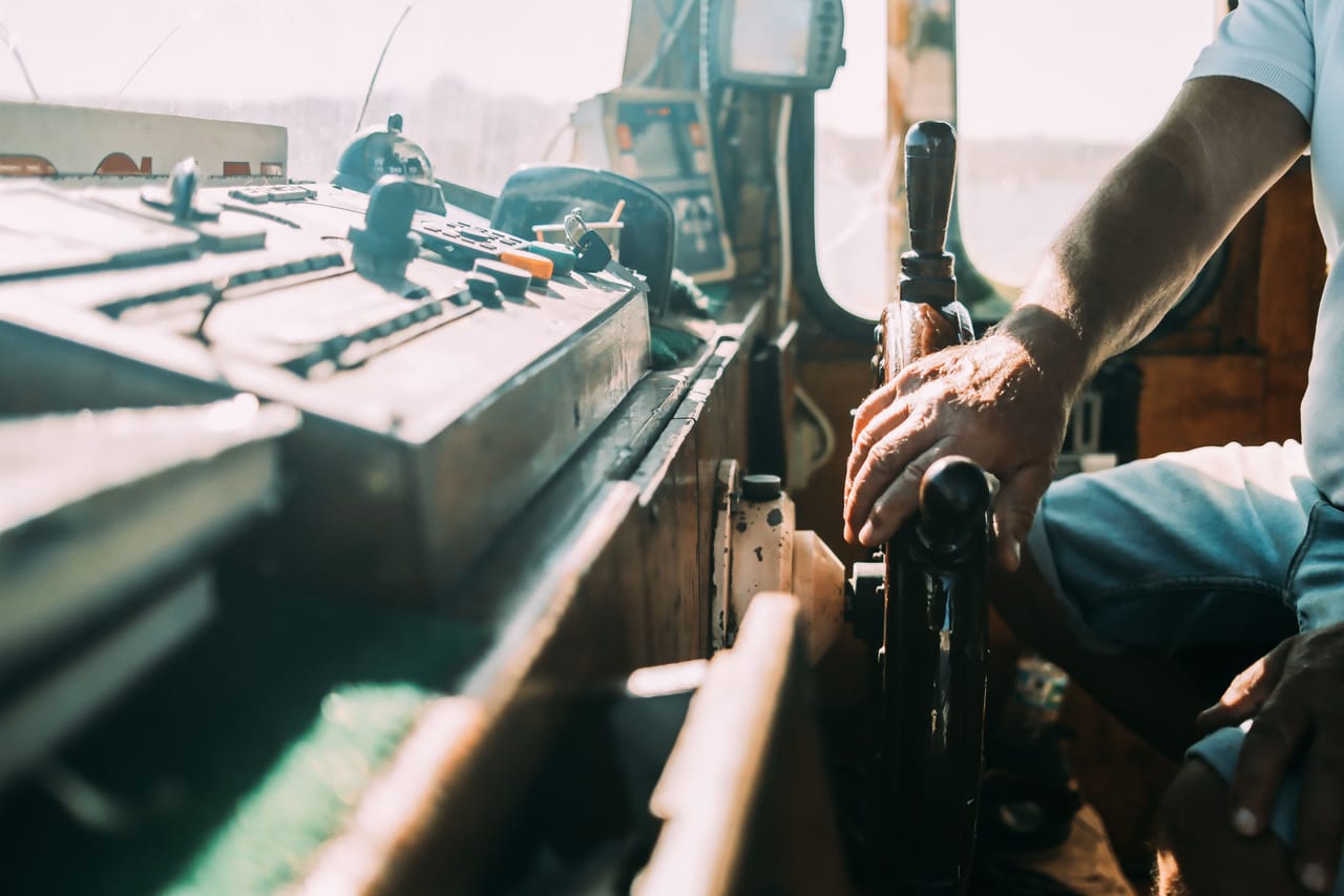 A Rote captain refuelling the outboard engine of a working boat before a surf run