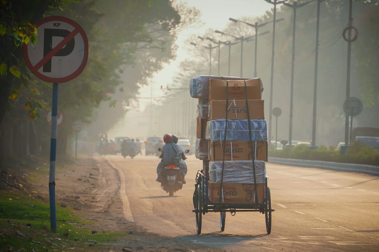 Motorbike loaded with boxes of supplies on a dirt road on Rote Island